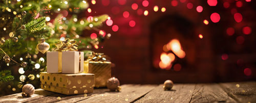 Christmas Tree with Decorations Near a Fireplace with Lights