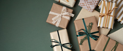 Christmas background with gift boxes over green backdrop. Xmas celebration, preparation for winter holidays, secret Santa, advent calendar concept. Festive banner, website header, top view, flat lay